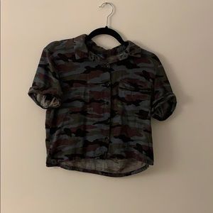 A loose camo button up comfortable arms are cuffed